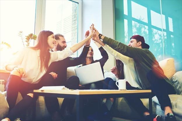 employees high-fiving in a circle