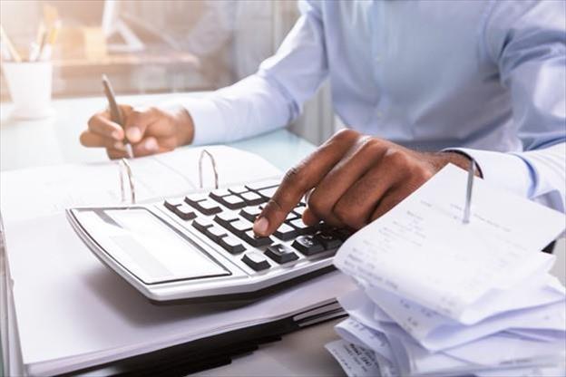 close up of employee using a calculator