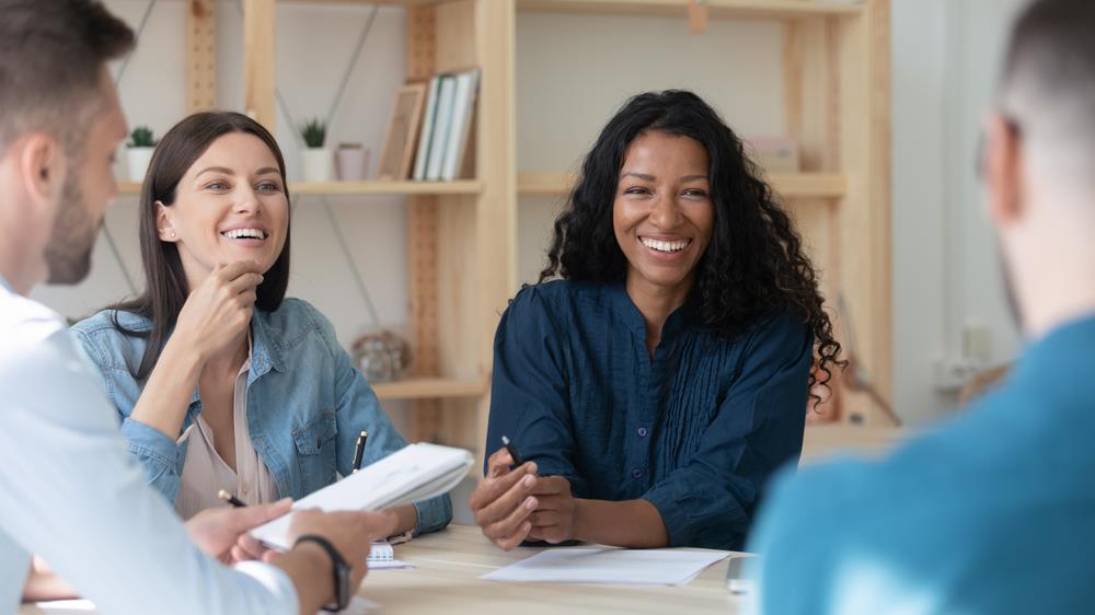 happy employees gathered around a table