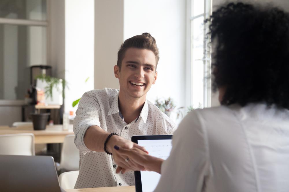 job seeker shaking hands with his interviewer during a part-time job interview