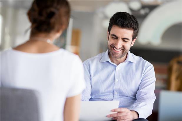 job seeker looking over his resume during a part-time job interview