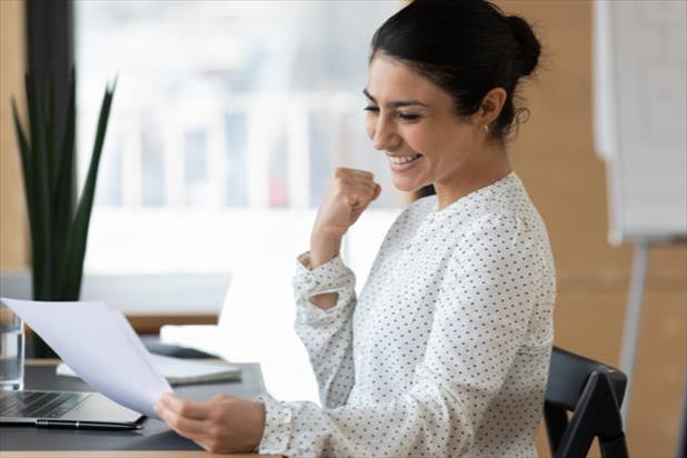 happy woman looking at document