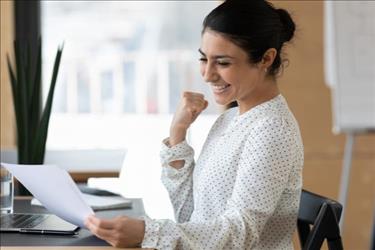 happy woman looking at document