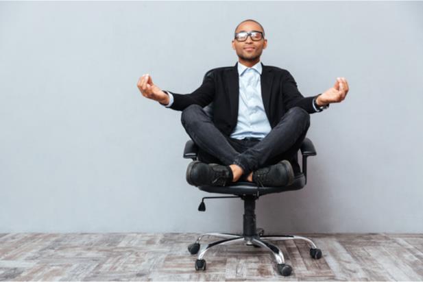 man meditating on chair