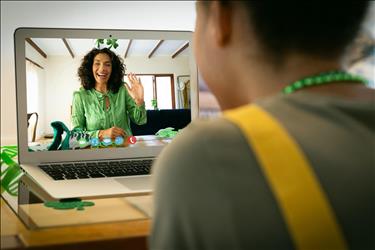 two friends meeting on a video call while celebrating st. patrick's day