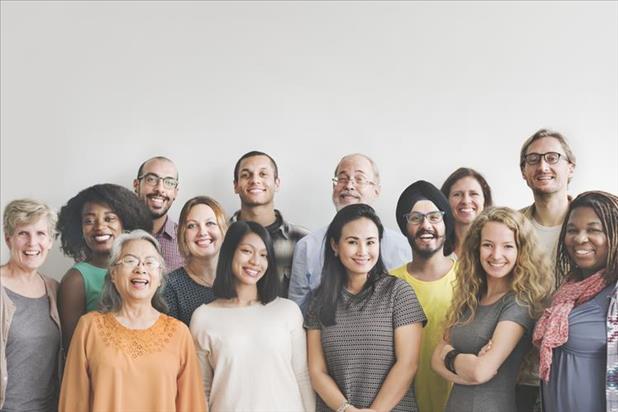 A group of diverse employees smiling for the camera