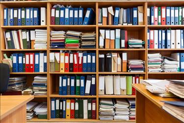 Wall of shelves with binders