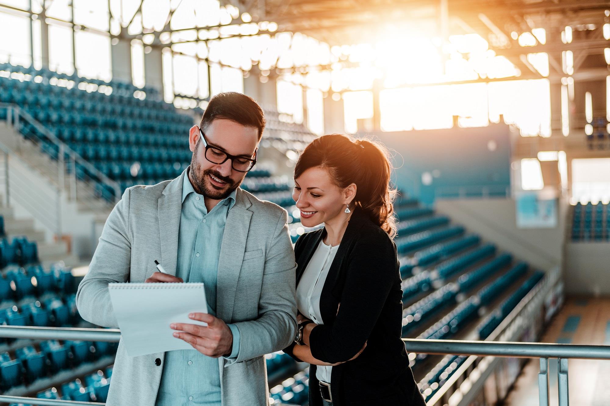 two sport management professionals meeting in an arena