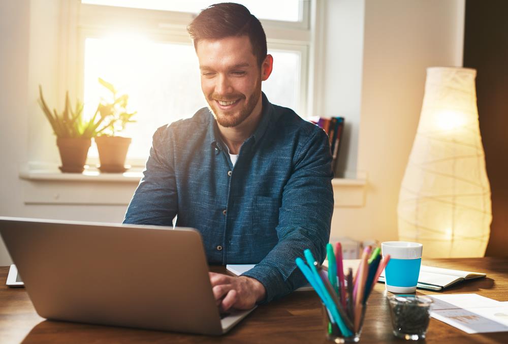 Recruiter sitting in front of his laptop and using templates to communicate with candidates