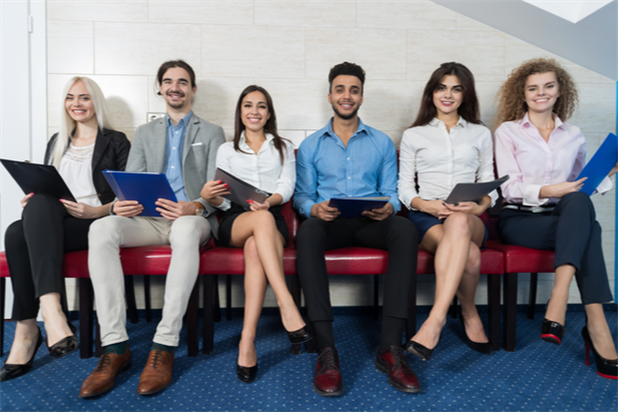 Group of job applicants waiting to speak to a recruiter