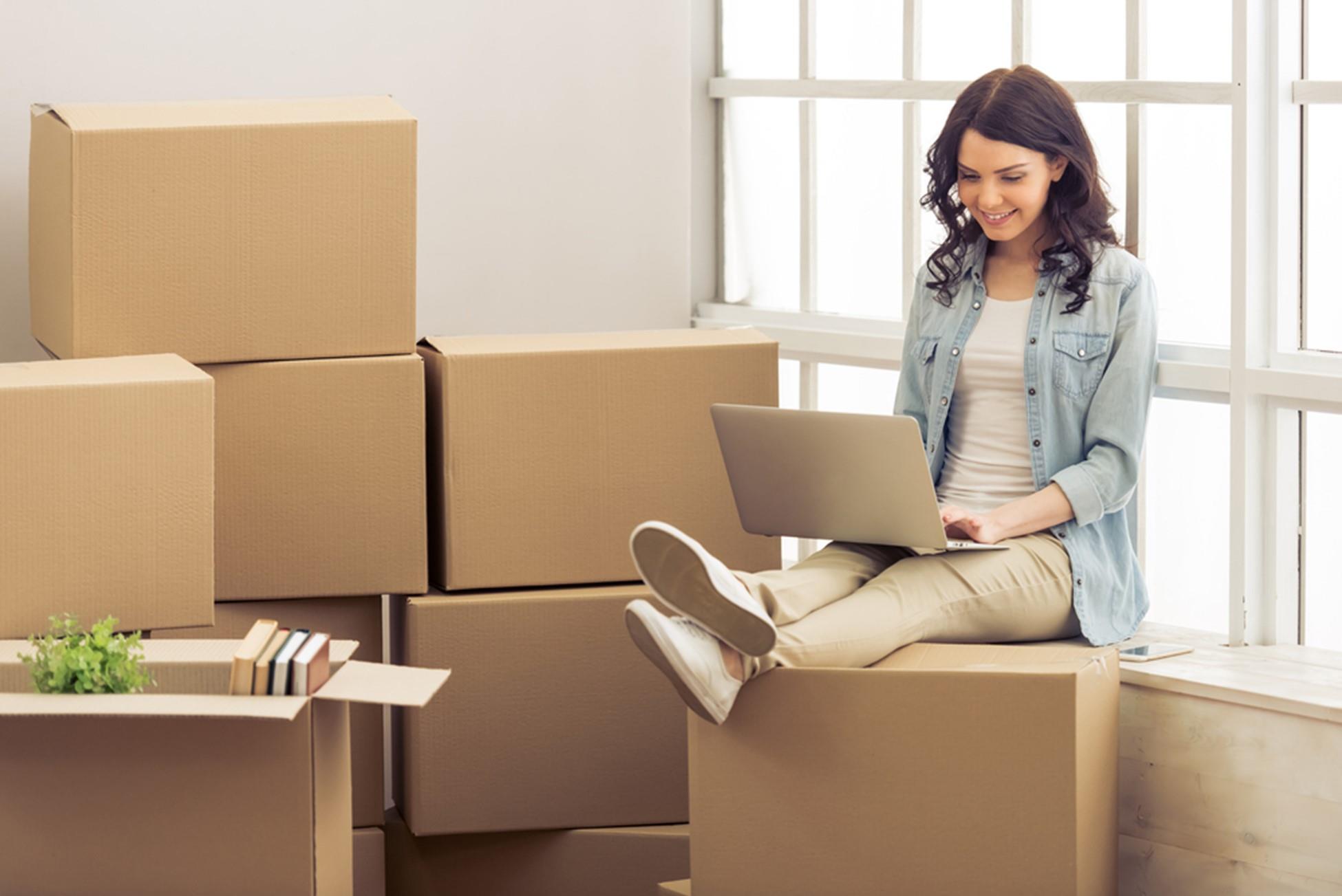 woman moving sitting on boxes