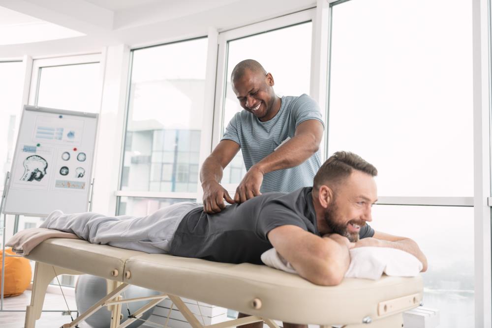 massage therapist giving a massage to a client