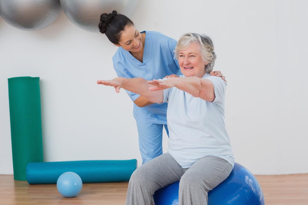 occupational therapist helping a client exercise