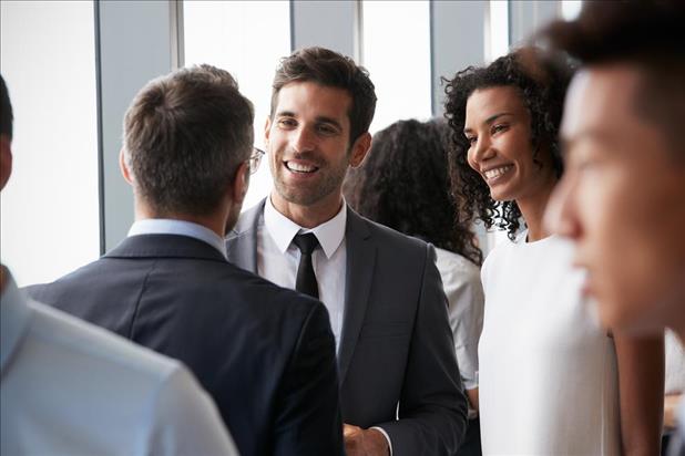 Group of professionals talking at networking event