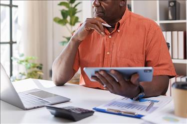 office manager doing budget calculations at his desk