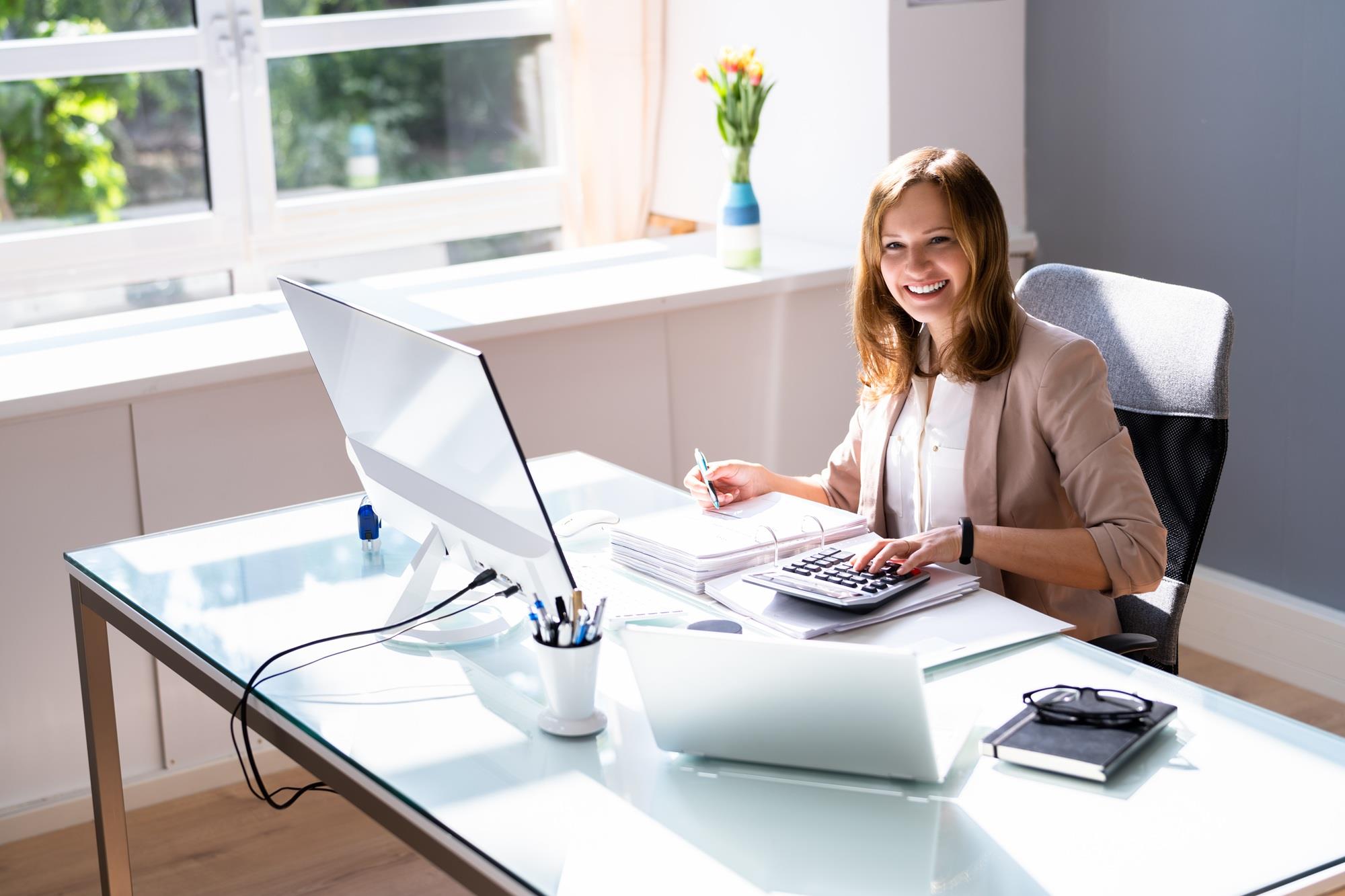 woman performing calculations at her desk