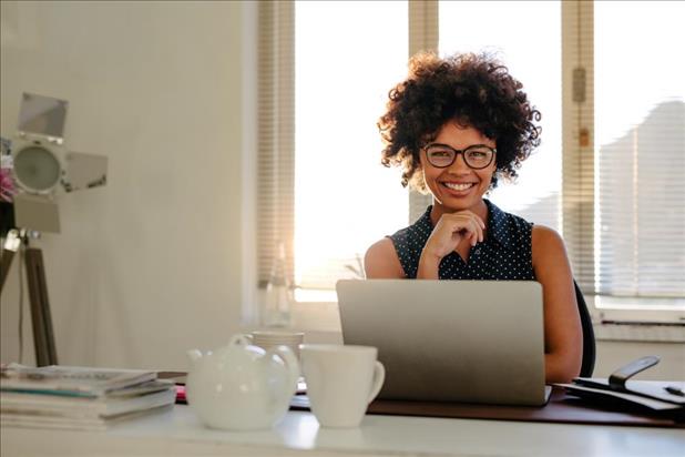 Young professional sitting in front of a computer in a clean office