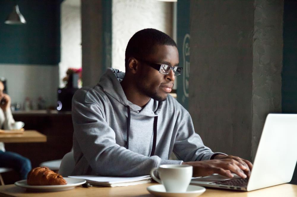 Man searching for jobs in cafe