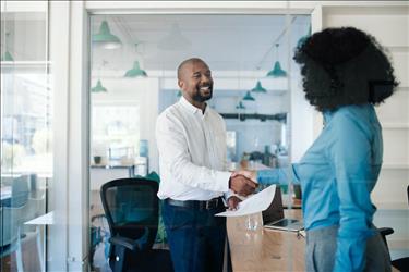 Woman shaking hands with hiring manager after interview