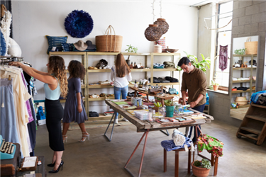 Staff and customers inside trendy clothing store