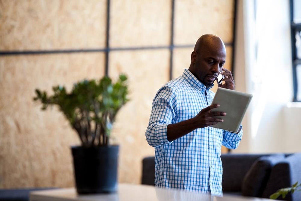 job seeker on his phone and tablet networking in his industry