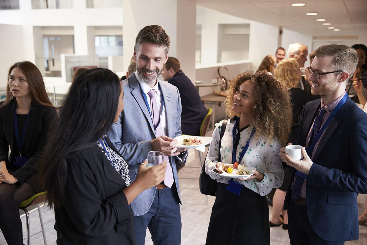 Networking Photo: People at a networking event eating and drinking.