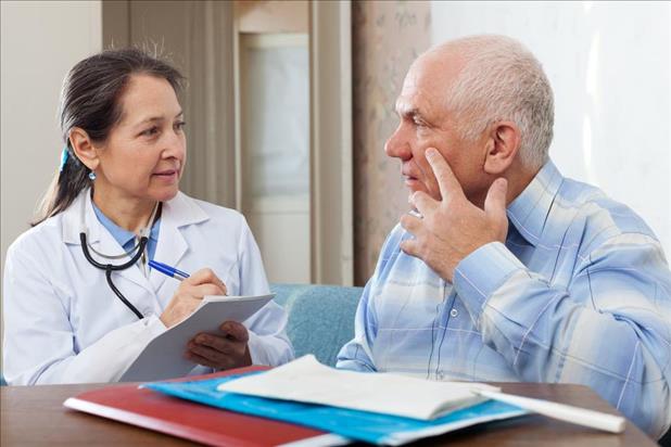 patient in a community health clinic explaining his eye symptoms to a medical provider