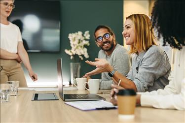 group of happy employees in a conference room