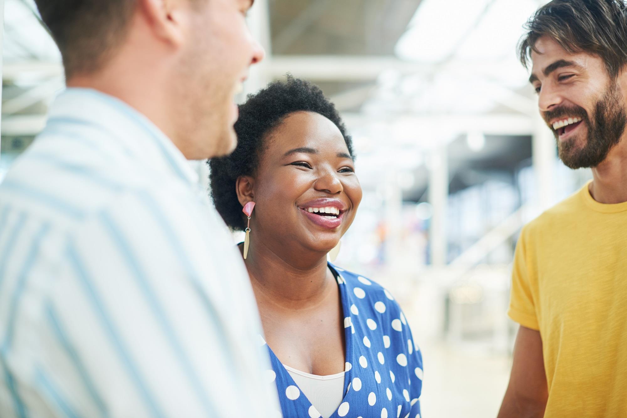 happy employee laughing with her coworkers