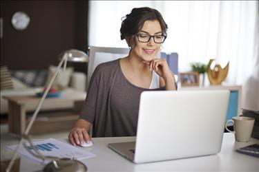 professional enjoying her remote part-time job while working on a laptop