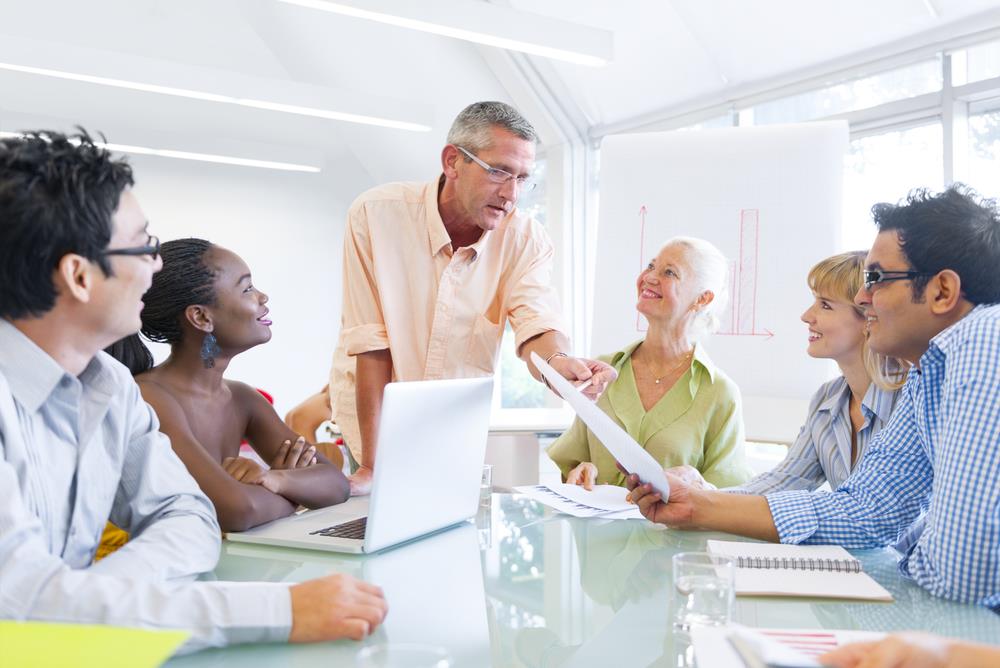 Man giving career coaching to a group of professionals