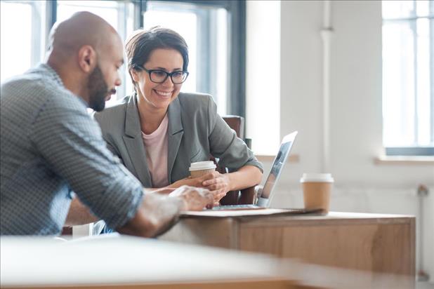 Business woman helping man with job search