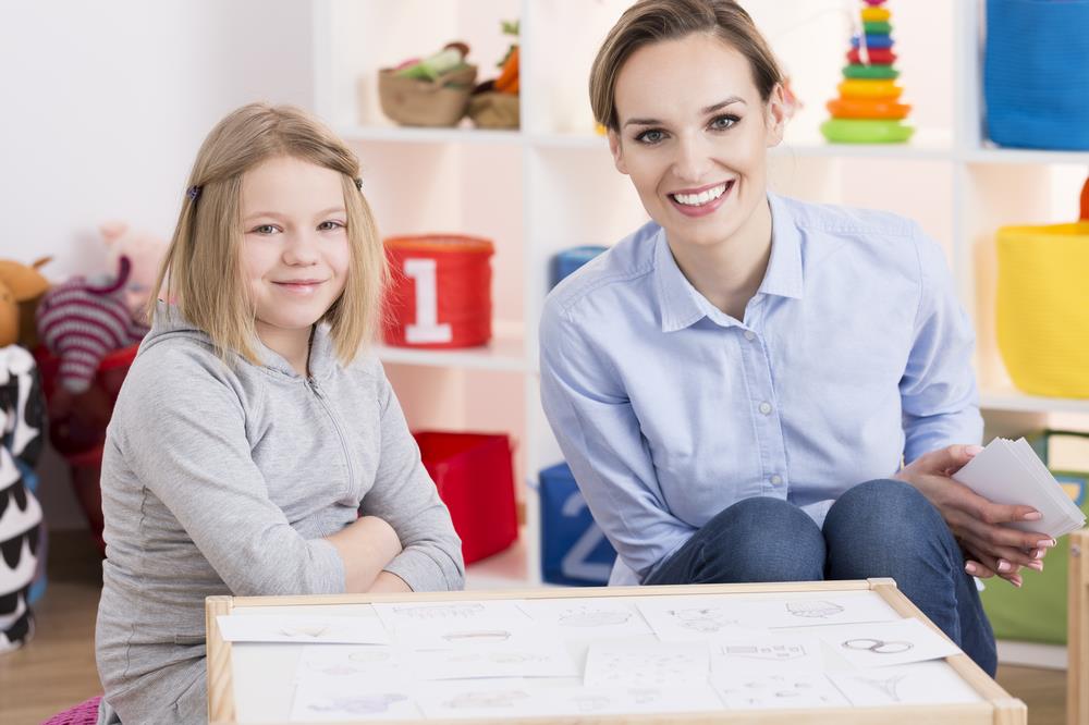 Special education teacher smiling with student