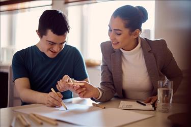 Special education teacher instructing student