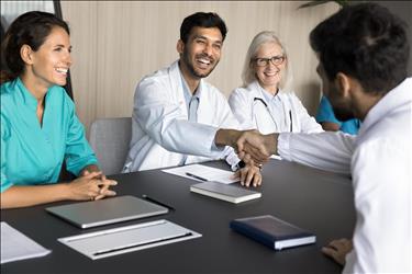 group of healthcare employees meeting with a new hire