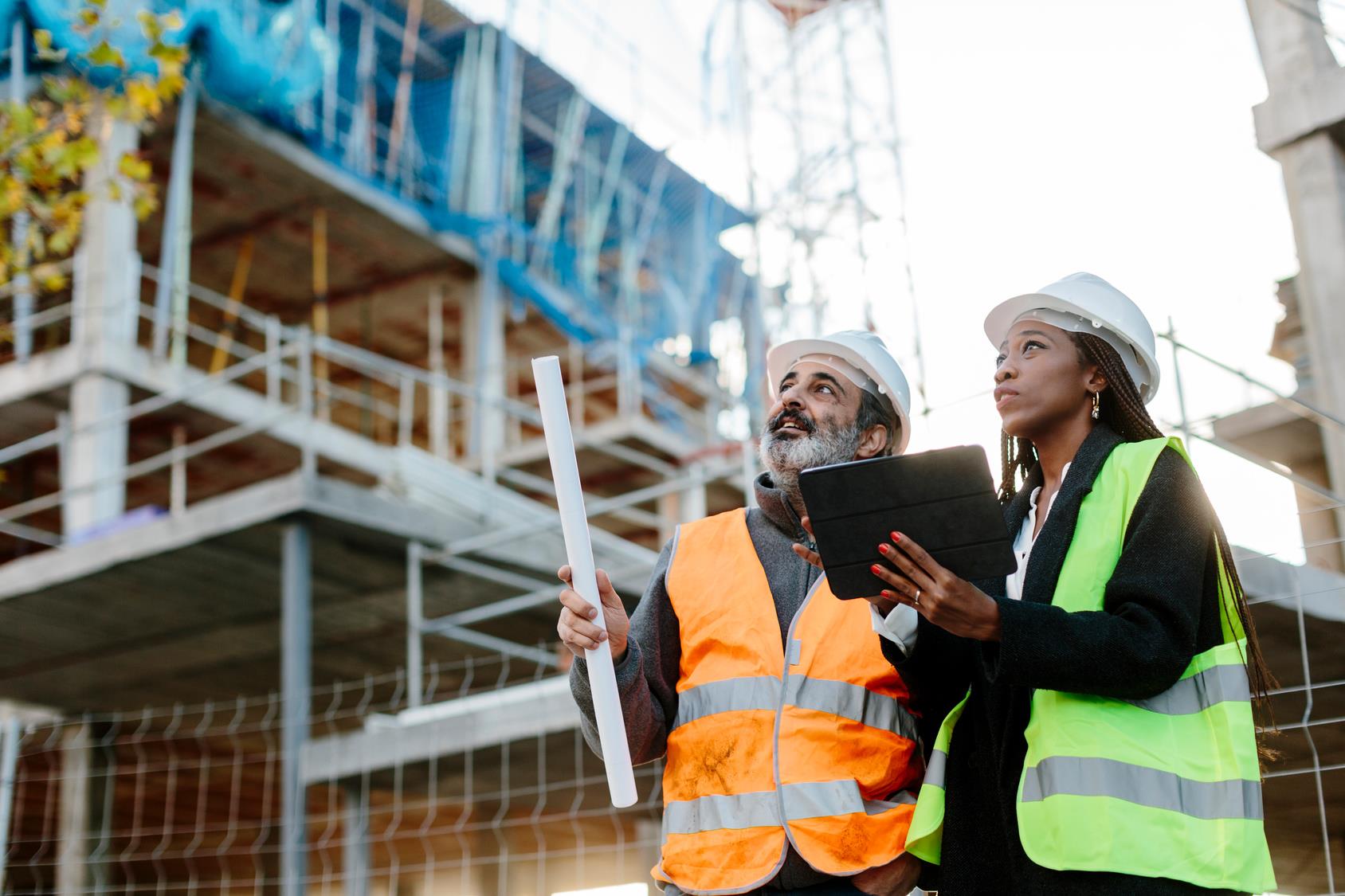 two construction workers looking at a site