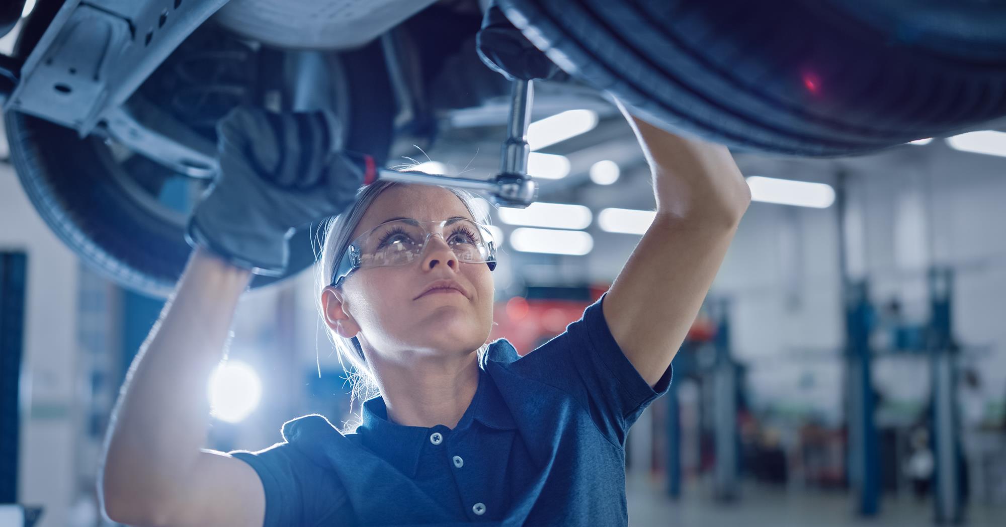 Automotive mechanic tuning up a car