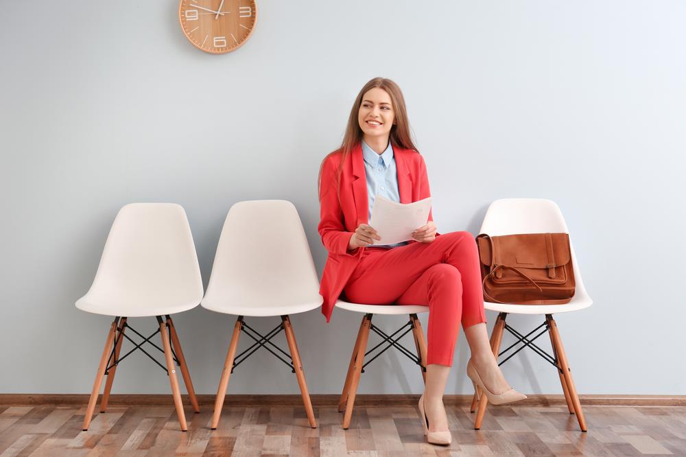 job seeker preparing for her interview by reviewing her notes in the lobby