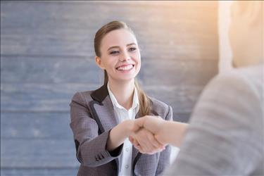 job seeker shaking hands with her interviewer