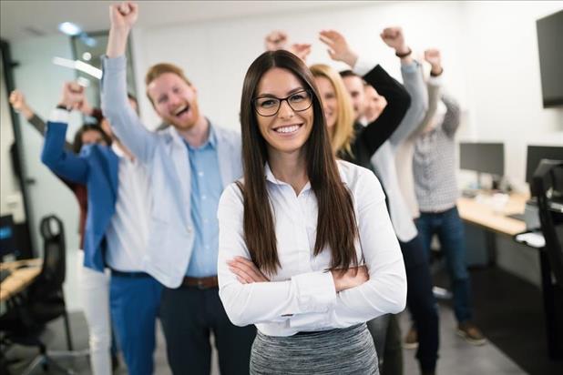 happy female employee being recognized by her team