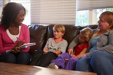 Social worker interviewing mother and two children