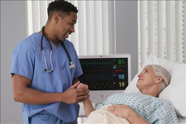 nurse smiling while caring for his patient