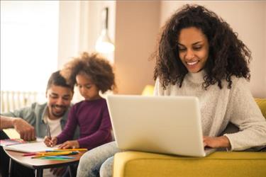 woman working from home with family in background