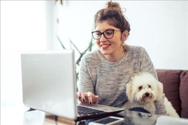 woman working from home with her dog