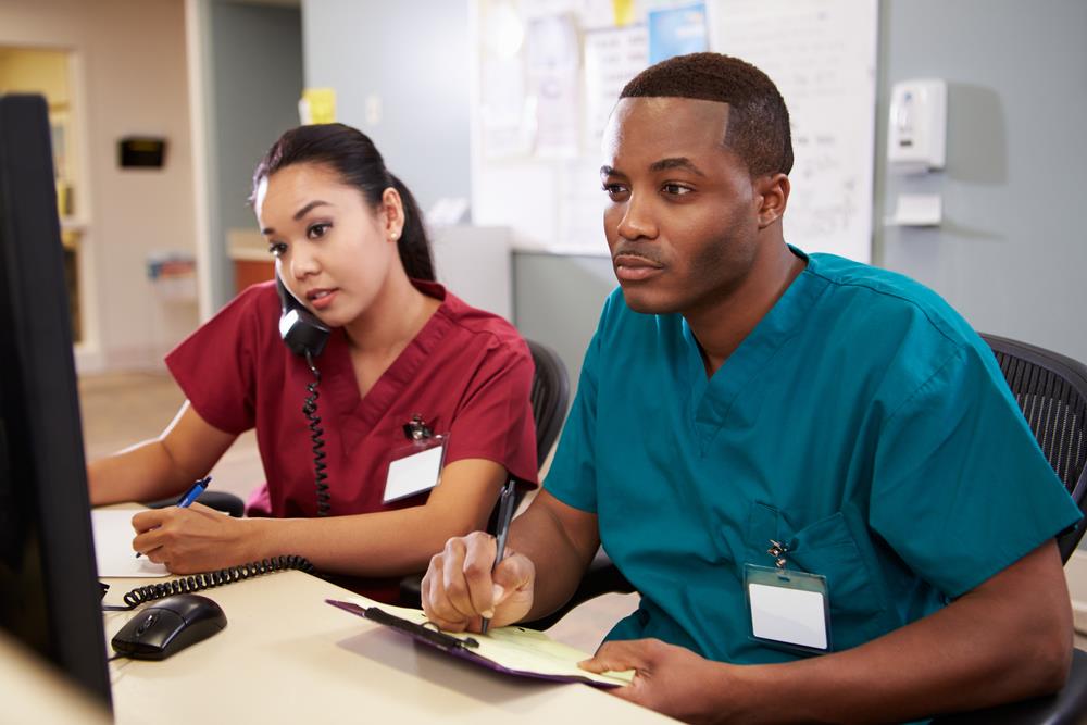 two nurse practitioners fielding patient calls in telemedicine office