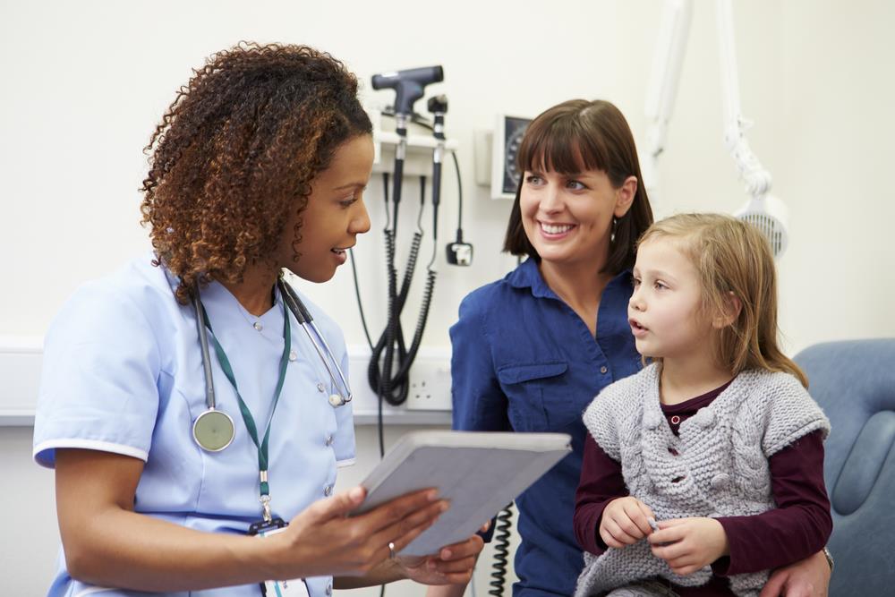 Nurse practitioner speaking with family in primary care setting