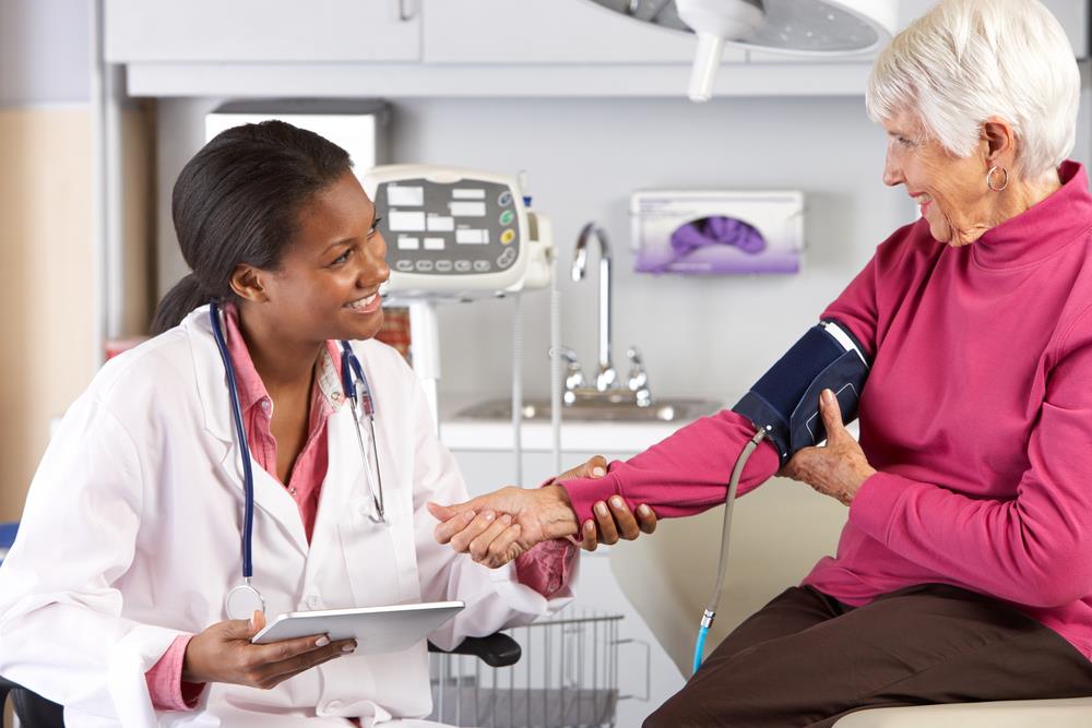 Nurse practitioner examining elderly patient