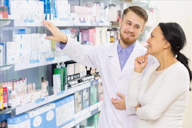 pharmacist assisting a customer with OTC medications