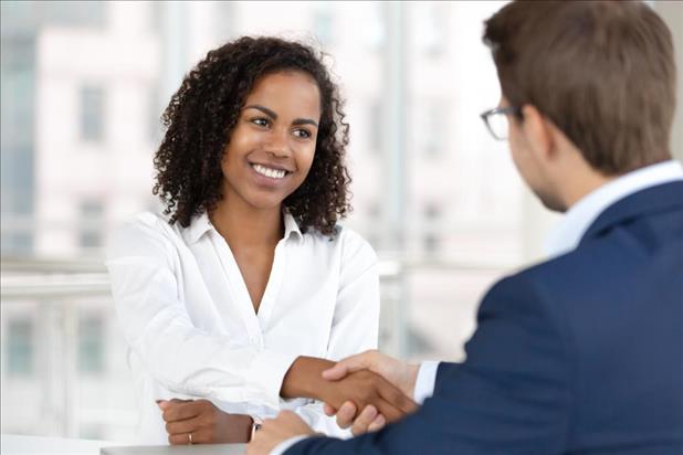 HR leader shaking hands with new employee