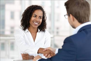 HR leader shaking hands with new employee